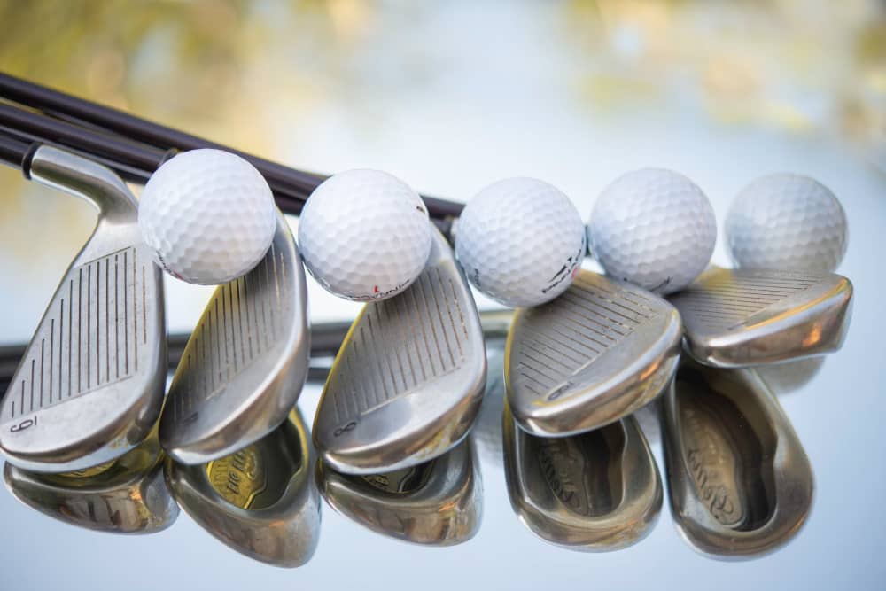 An array of golf club irons and balls, showcasing the variety and choice available to golfers at any skill level.