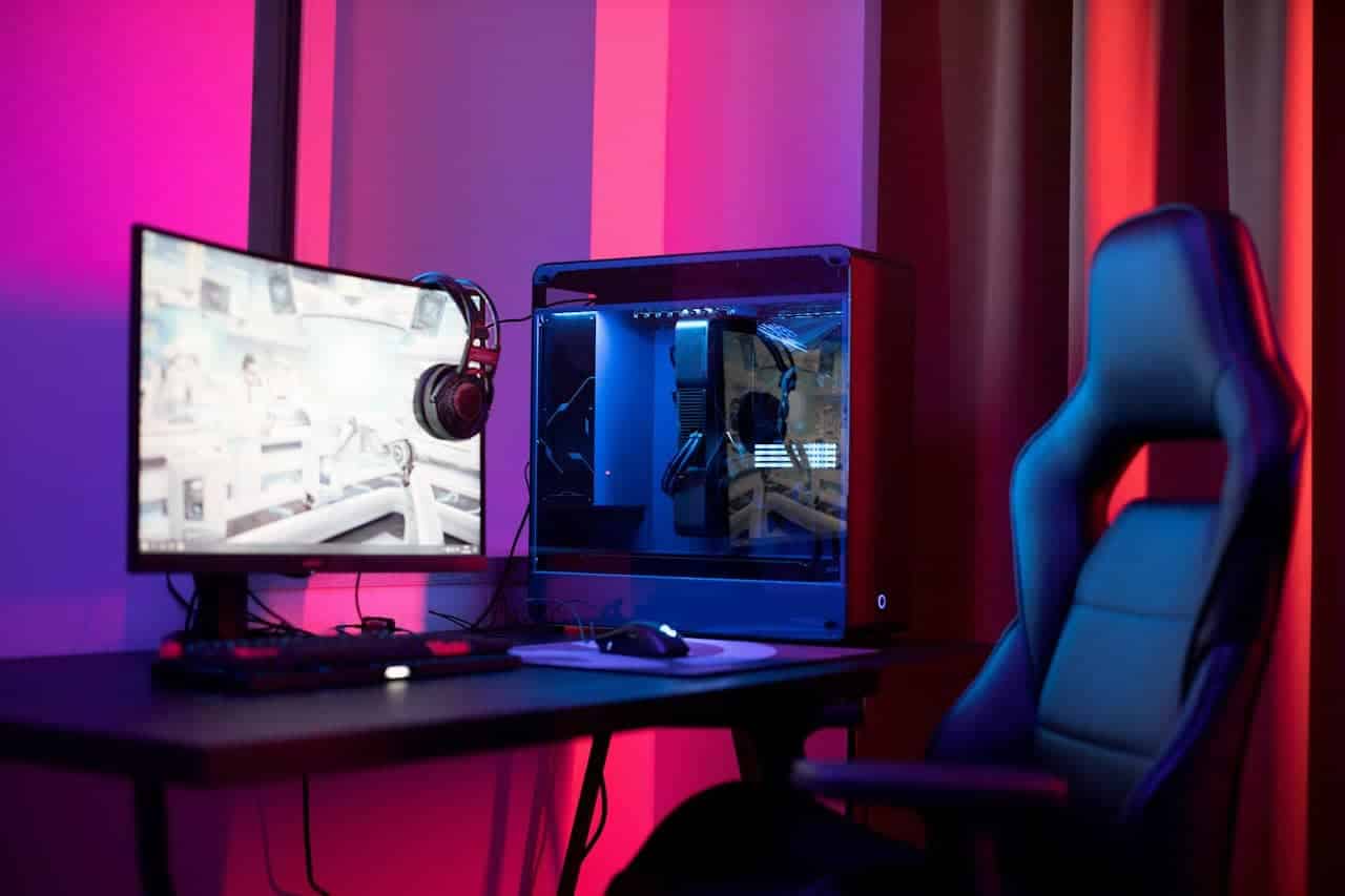 Gaming setup with a computer displaying a soccer video game, representing the convergence of sports and iGaming.